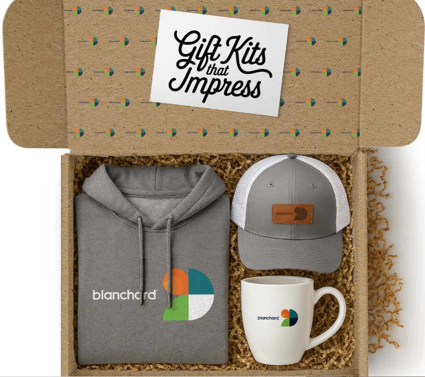 Branded Blanchard gift kit — canvas tote, embossed journal, insulated tumbler, lapel pin, wool throw, and hand-written notecard.